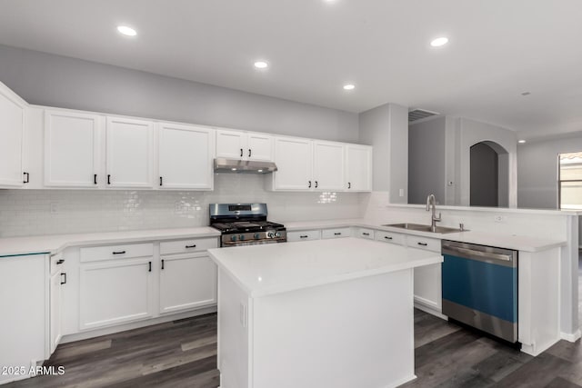 20919 E Desert Hills Blvd, Queen Creek, AZ 85142 - kitchen with dishwashing machine, stainless steel range with gas cooktop, under cabinet range hood, a peninsula, and dark wood finished floors