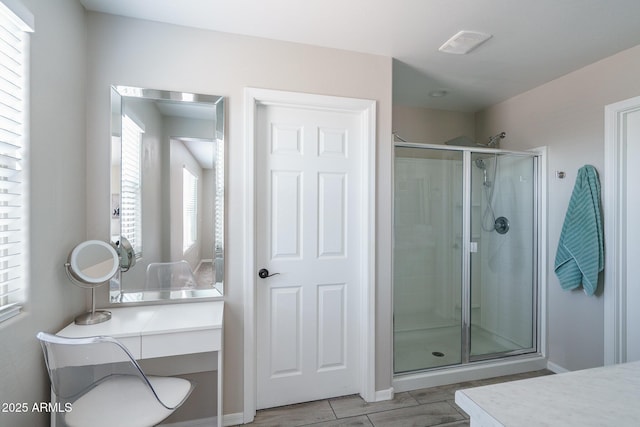 bathroom featuring a shower stall and vanity