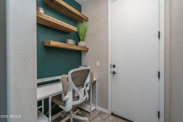 office with light wood-style flooring and baseboards