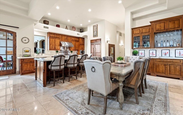 dining room with a towering ceiling