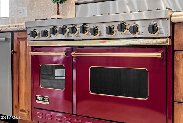details featuring range with two ovens and decorative backsplash