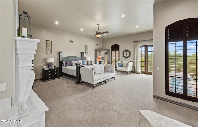 carpeted bedroom with access to outside, recessed lighting, visible vents, ceiling fan, and arched walkways