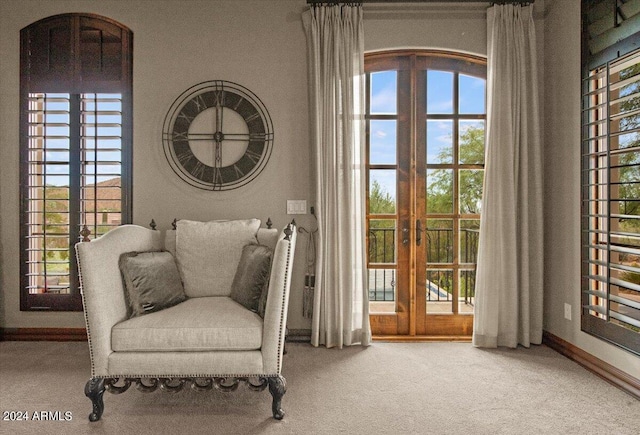 living area featuring french doors, carpet, and plenty of natural light