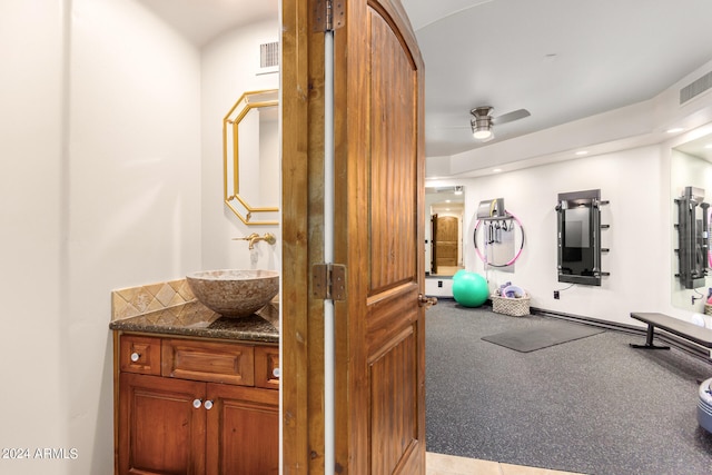 exercise area featuring ceiling fan and sink