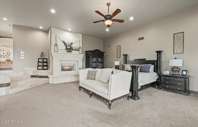 bedroom featuring ceiling fan, a fireplace, and carpet flooring