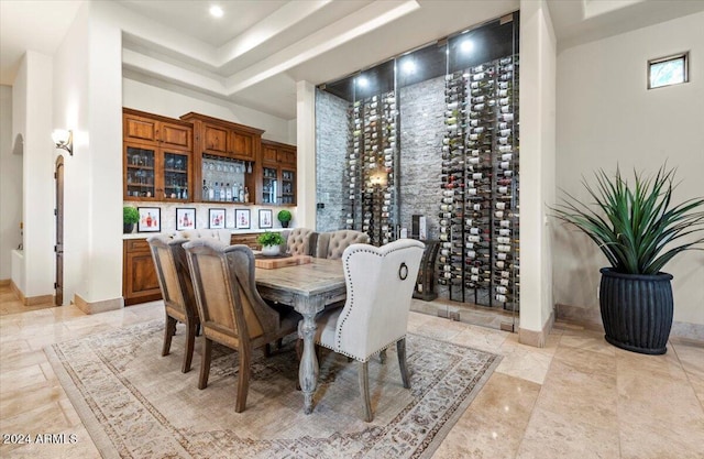 dining area featuring baseboards and a raised ceiling