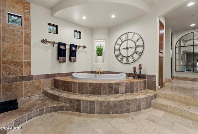 bathroom featuring tiled bath