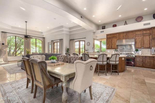 dining space featuring visible vents, recessed lighting, a raised ceiling, and a ceiling fan
