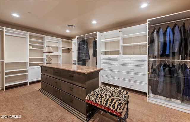 spacious closet featuring light carpet