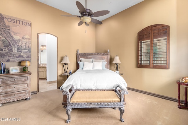 carpeted bedroom with lofted ceiling, ensuite bath, and ceiling fan