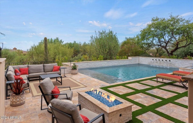 view of pool featuring a fenced in pool, a patio area, and an outdoor living space with a fire pit