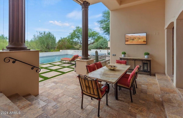 view of patio / terrace featuring a pool and outdoor dining space