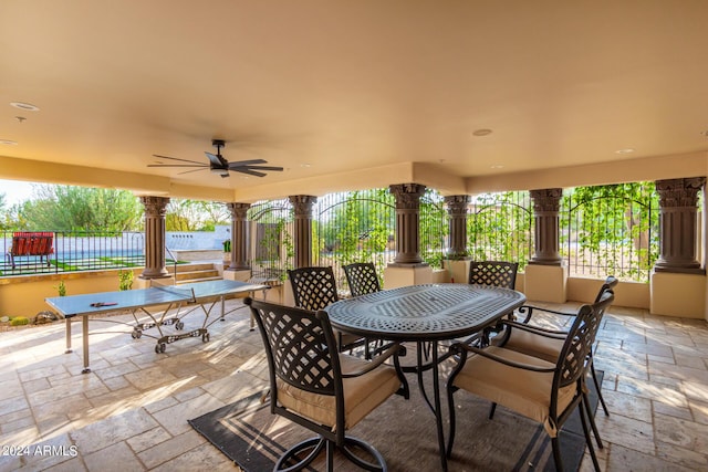 view of patio / terrace with fence, a ceiling fan, and outdoor dining area