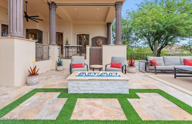 view of patio featuring an outdoor living space with a fire pit, ceiling fan, and fence