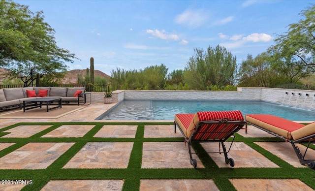 view of pool featuring pool water feature, a patio, and an outdoor hangout area