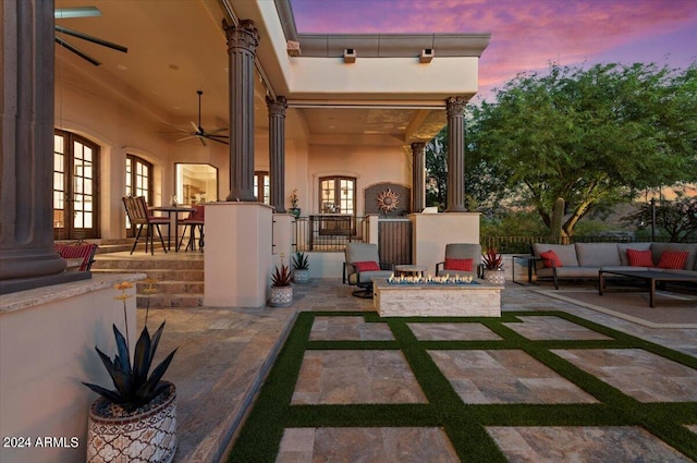 patio terrace at dusk with ceiling fan and an outdoor hangout area