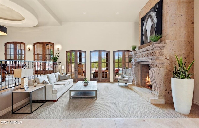living room with french doors, a fireplace, and a towering ceiling