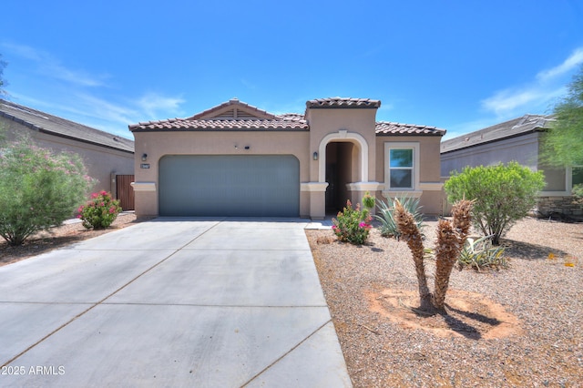 36467 W Pampoloma Ave, Maricopa, AZ 85138 - mediterranean / spanish house featuring concrete driveway, a garage, stucco siding, and a tile roof