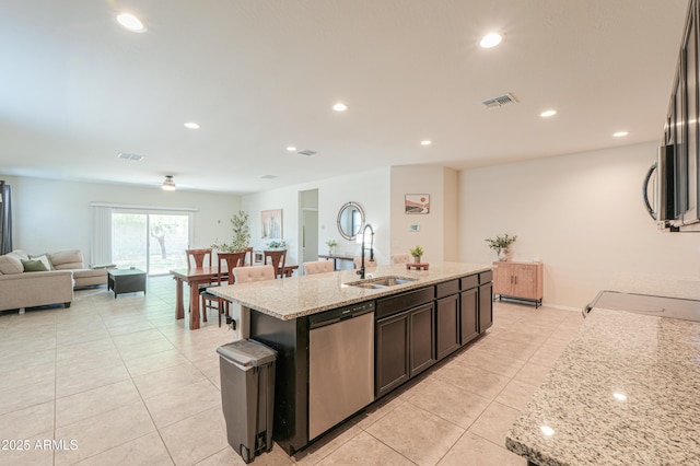 36467 W Pampoloma Ave, Maricopa, AZ 85138 - kitchen featuring a sink, appliances with stainless steel finishes, light tile patterned floors, open floor plan, and light stone countertops