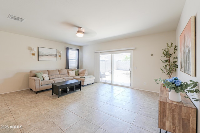 36467 W Pampoloma Ave, Maricopa, AZ 85138 - living room featuring light tile patterned floors, a ceiling fan, and baseboards