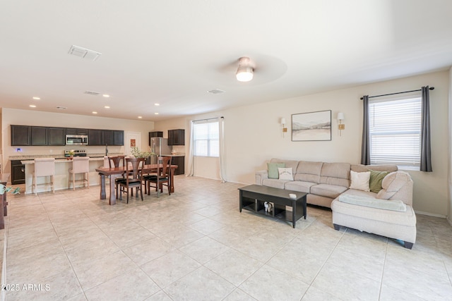 36467 W Pampoloma Ave, Maricopa, AZ 85138 - living room with light tile patterned flooring, recessed lighting, a ceiling fan, and baseboards
