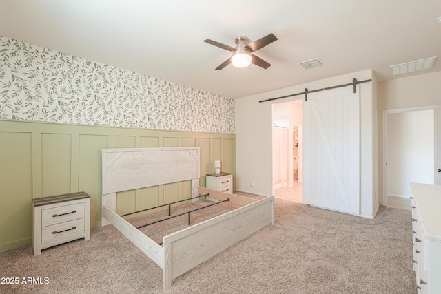 36467 W Pampoloma Ave, Maricopa, AZ 85138 - unfurnished bedroom featuring wallpapered walls, wainscoting, a barn door, carpet, and a decorative wall
