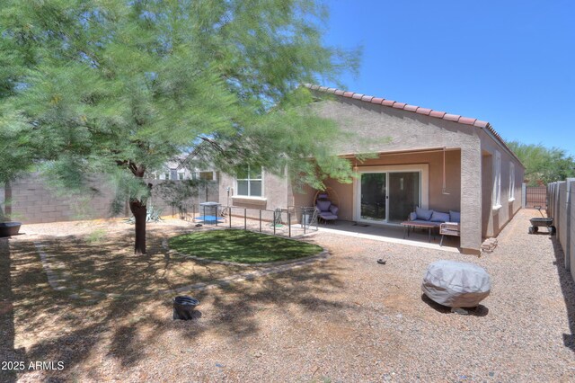 36467 W Pampoloma Ave, Maricopa, AZ 85138 - rear view of house featuring an outdoor hangout area, stucco siding, a fenced backyard, and a patio area