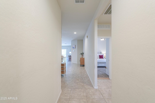 36467 W Pampoloma Ave, Maricopa, AZ 85138 - corridor featuring light tile patterned floors, a textured wall, and baseboards