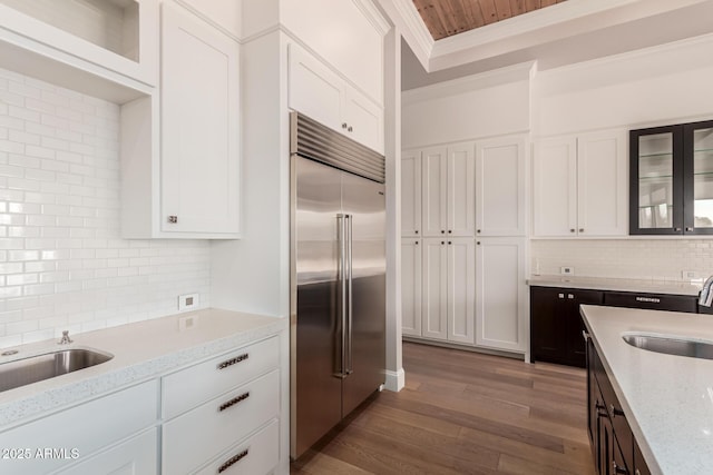 kitchen featuring white cabinetry, sink, and stainless steel built in fridge