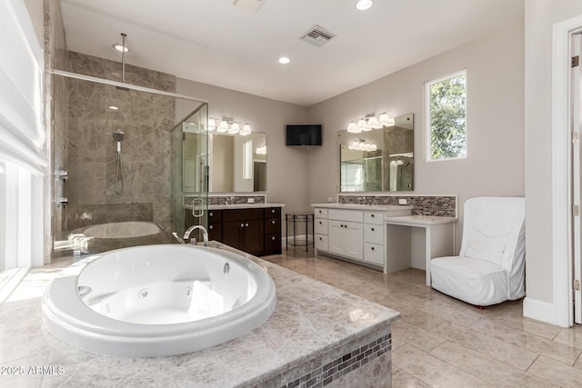 bathroom with vanity and independent shower and bath