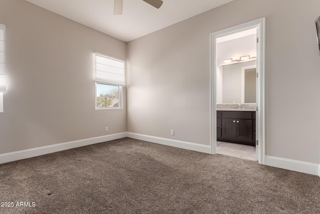 unfurnished bedroom featuring light carpet, sink, ensuite bath, and ceiling fan