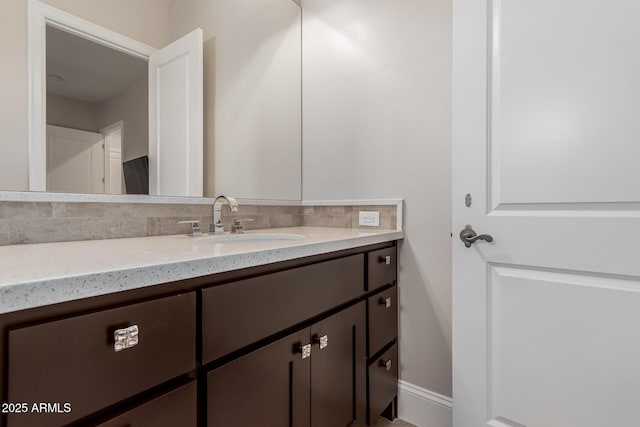 bathroom featuring vanity and backsplash