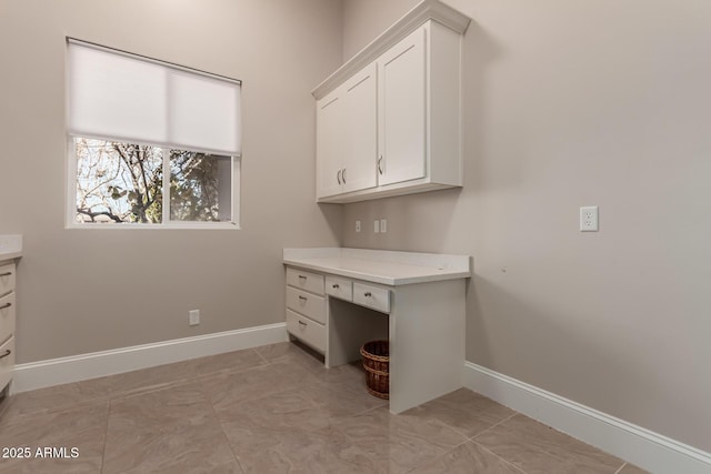 unfurnished office featuring light tile patterned flooring