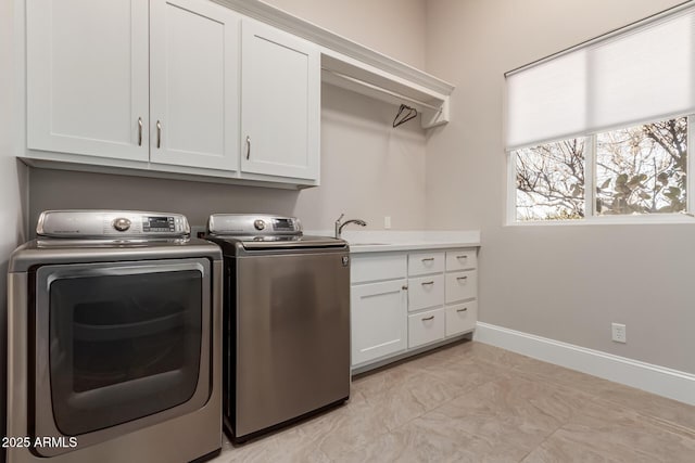 clothes washing area featuring cabinets, independent washer and dryer, and sink