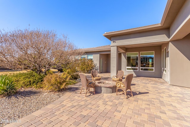 view of patio with an outdoor fire pit