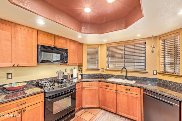 kitchen featuring light tile patterned floors, recessed lighting, black appliances, a raised ceiling, and a sink