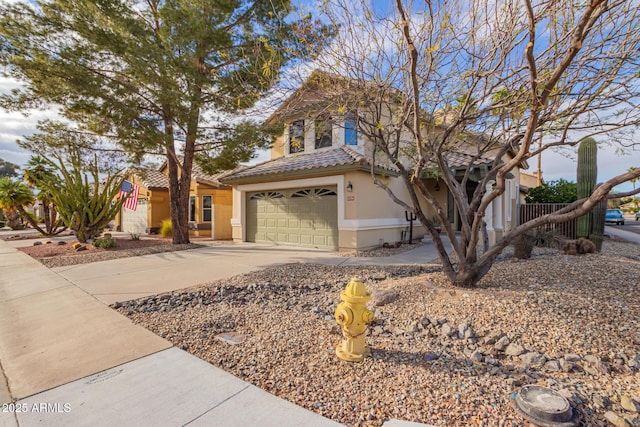 traditional home featuring stucco siding, concrete driveway, and a tiled roof