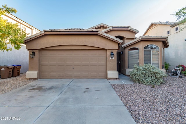 813 E Lovegrass Dr, San Tan Valley, AZ 85143 - view of front of property featuring concrete driveway, stucco siding, a garage, and a tiled roof