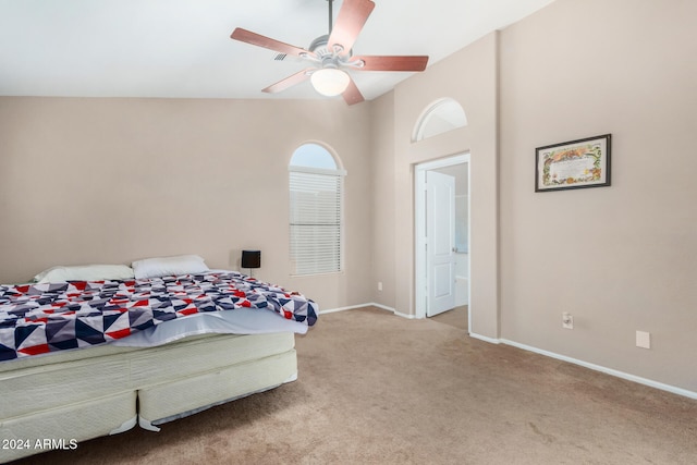 bedroom featuring light colored carpet, high vaulted ceiling, and ceiling fan