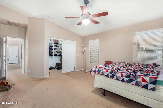 carpeted bedroom featuring ceiling fan, a closet, and vaulted ceiling