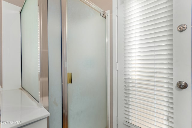 bathroom featuring a shower with door