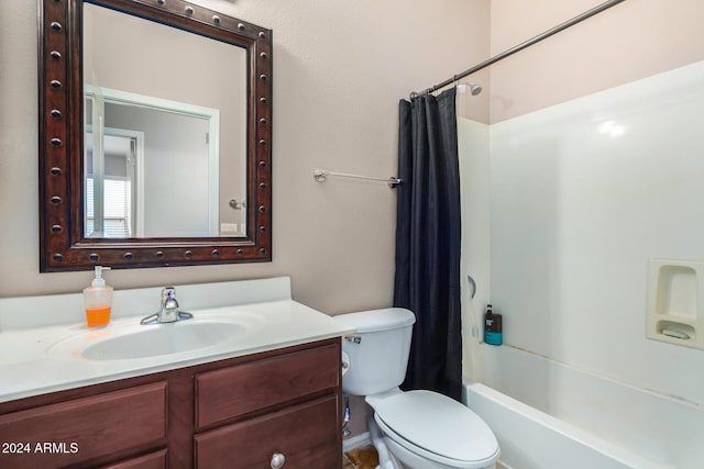 full bathroom with vanity, shower / tub combo, and toilet