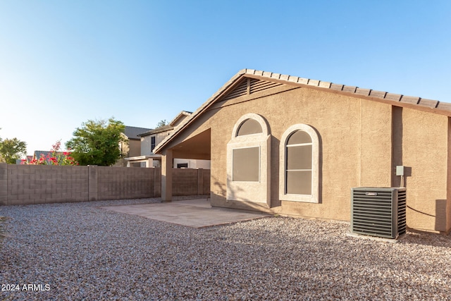 back of property with a patio and central AC unit