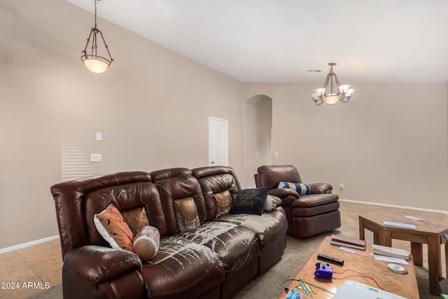 home theater with a chandelier, light tile patterned floors, and vaulted ceiling