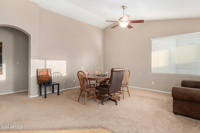 carpeted dining room featuring ceiling fan and lofted ceiling