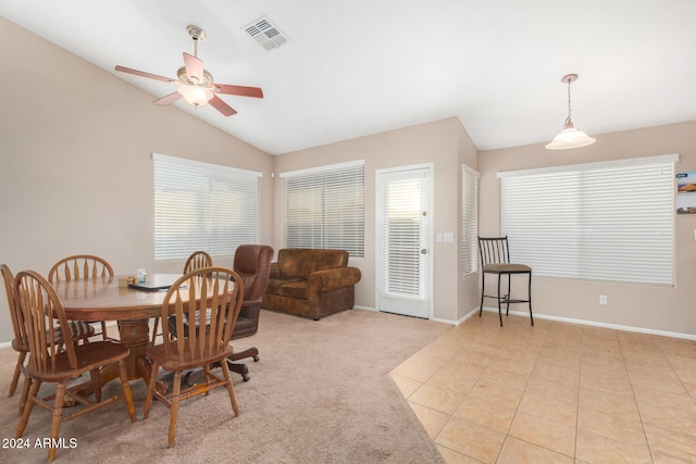 dining space featuring vaulted ceiling, ceiling fan, and light tile patterned flooring