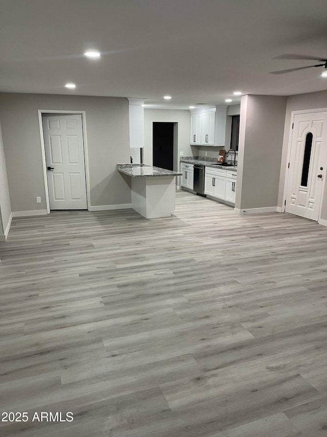 kitchen with white cabinetry, dishwashing machine, recessed lighting, and baseboards