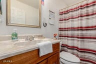 bathroom with vanity, toilet, and walk in shower