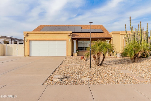 view of front of home with a garage and solar panels