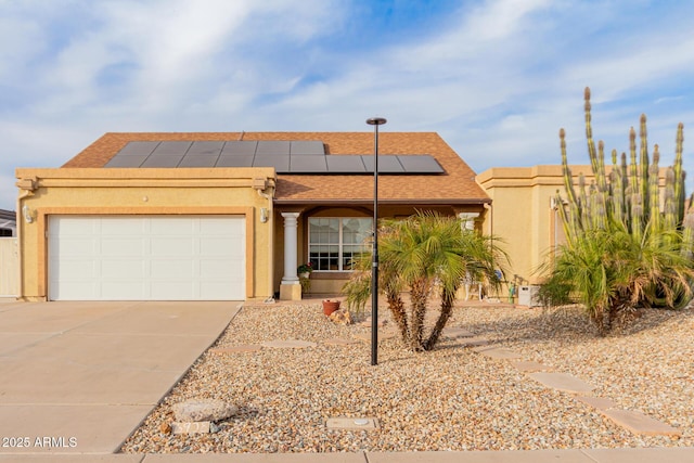 view of front of house featuring a garage and solar panels